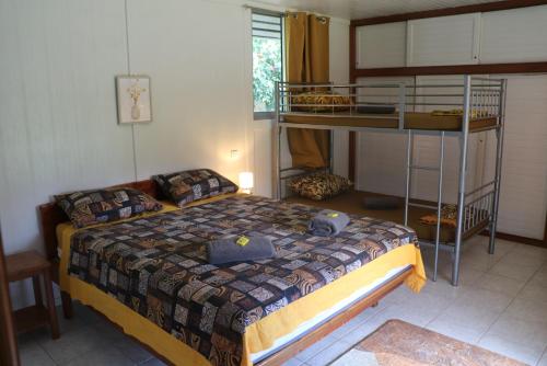 a bedroom with a bed and a bunk bed at TEVIHOUSE 2 Bedrooms House or-and Bungalow with Pool in Taravao