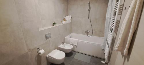 een badkamer met een toilet, een bad en een wastafel bij Apartment Varaždin in Varaždin