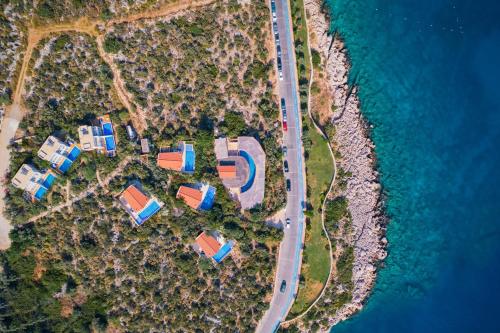 an aerial view of a house and the ocean at Likya Pavilion Hotel in Kas