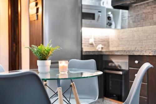 a table with a plant on it in a kitchen at Ático Miranda in Icod de los Vinos