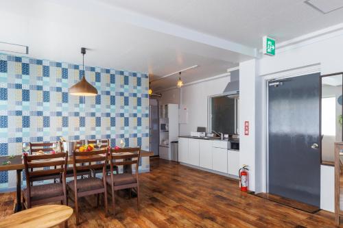 a kitchen and dining room with a table and chairs at Residential Hotel Naha Miebashi in Tomari