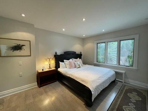 a bedroom with a large bed and a window at Private Suite in Forest Hill with full kitchen and parking in Toronto