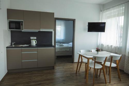 a kitchen and dining room with a table and chairs at Apartmány Pemag Mikulov in Mikulov