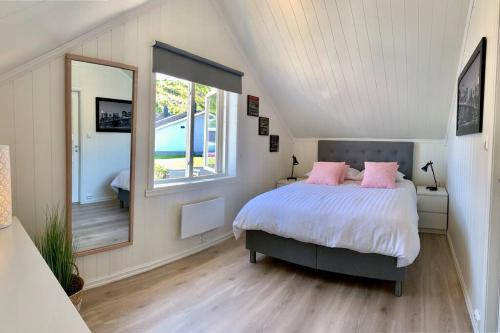 ein Schlafzimmer mit einem Bett und einem großen Fenster in der Unterkunft NorSpan Lodge - Lofoten with Seaview in Stamsund