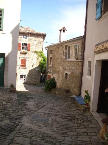an alley with two old buildings and a cobblestone street at Rooms Svalina in Grožnjan