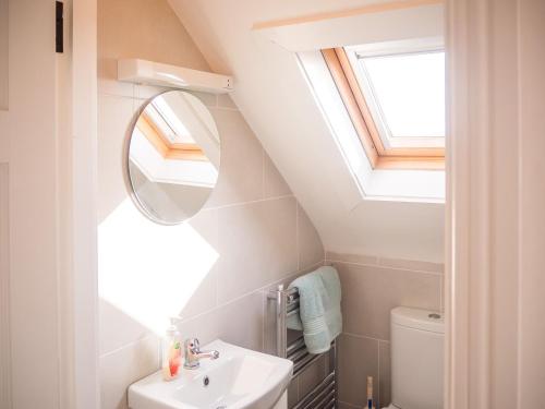a bathroom with a sink and a mirror at 14 Leitirshask, Ballyconneely in Ballyconneely
