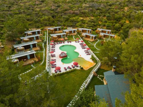 an aerial view of a resort with a pool and tables at Mossa Afkule Kayaköy in Fethiye