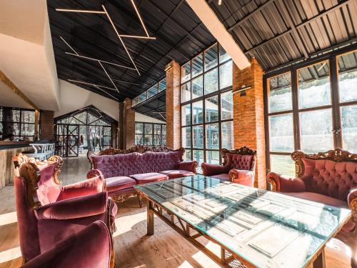 a room with a table and chairs and windows at Mossa Afkule Kayaköy in Fethiye