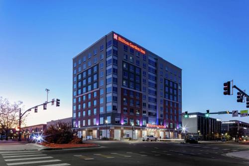 a tall building on a city street at night at Hilton Garden Inn Colorado Springs Downtown, Co in Colorado Springs