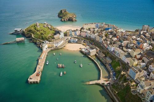 an aerial view of a beach with boats in the water at Pearl Shepherds Hut in Penally