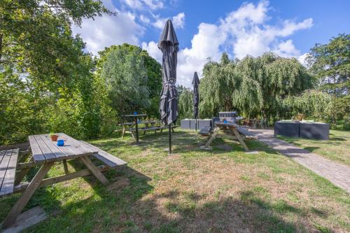 a picnic table and an umbrella in a park at Amrâth Airport Hotel Rotterdam in Rotterdam