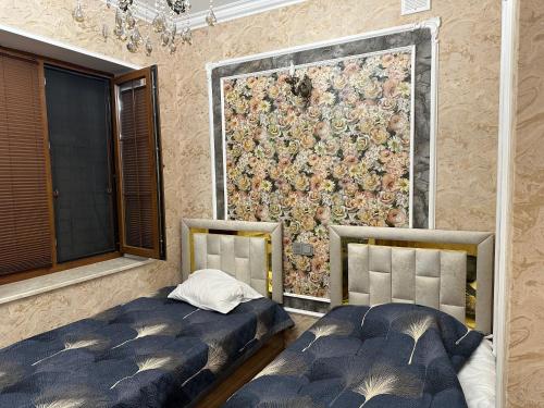 Duas camas num quarto com uma grande parede em Katej em Quba