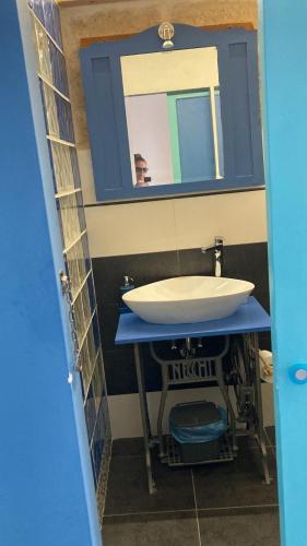 a bathroom with a sink and a mirror at A Casa di Lu in Minervino di Lecce