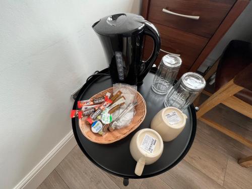 a table with a coffee maker and a basket on it at Cosy Double Room City Centre in Edinburgh