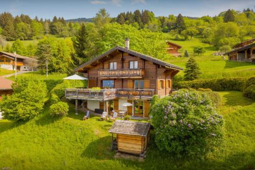 an aerial view of a house in a field at Chalet Isatys - OVO Network in Manigod