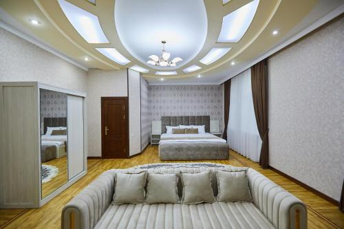 a living room with a couch and a bed at Elite Art Hotel in Tashkent