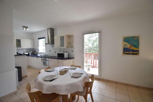 une cuisine avec une table et un chiffon de table blanc dans l'établissement Estrella - Hossegor centre ville magnifique appartement avec parking, à Soorts-Hossegor