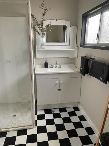 a bathroom with a sink and a mirror at Bullock and Company Cottage in Toodyay