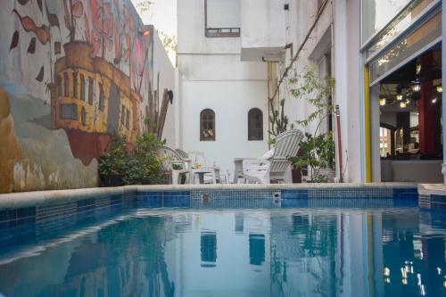 a swimming pool in the middle of a building at Hotel Ibiza in Villa Gesell
