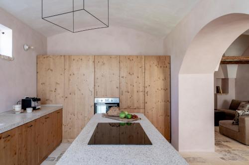a kitchen with a kitchen island with a counter top at Casale Madre in Ostuni