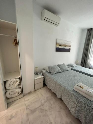 a bedroom with a bed and a mirror at The Spot Central Hostel in Seville