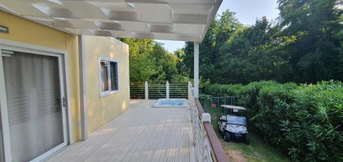 a porch of a house with a deck at Corte Attilea in Valeggio sul Mincio