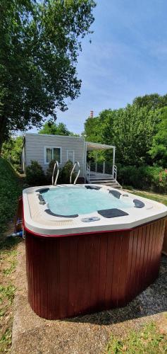 a large hot tub sitting in a yard at Corte Attilea in Valeggio sul Mincio