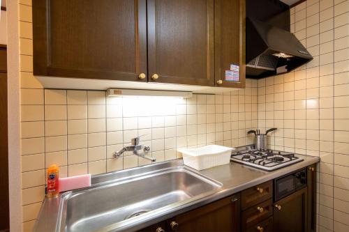 a kitchen with a sink and a stove at Nature Flower House in Ohanajaya in Tokyo