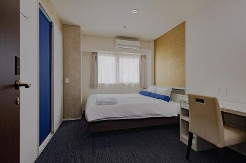 a small room with a bed and a desk and a desk at Folio Sakura Shinsaibashi Osaka by Banyan Group in Osaka