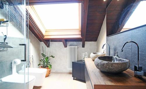 a bathroom with two sinks and a large stone sink at IL SALICE in Novara