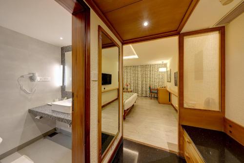 a bathroom with a sink and a mirror at The Central Park in Pune