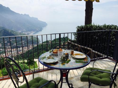 a table with food on top of a balcony with a view at La Casa di Vania in Ravello