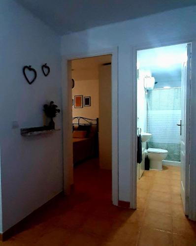 a hallway with a bathroom and a toilet in a room at Caracola Beach in Matalascañas