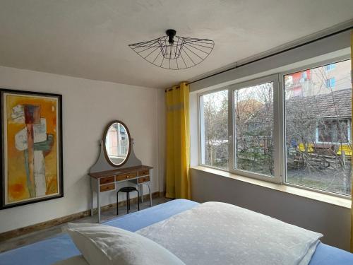 a bedroom with a bed and a window at Art Apartments Govora Cluj in Cluj-Napoca