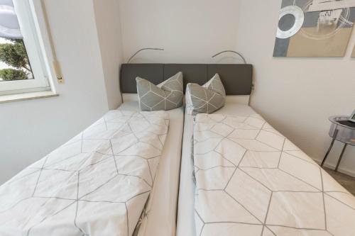 a bed with two pillows on it in a room at Griesbaum in Tengen