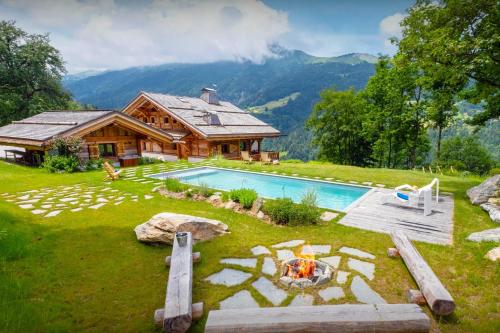 a house with a swimming pool in the yard at Chalet Beau Caillou - OVO Network in Saint-Gervais-les-Bains