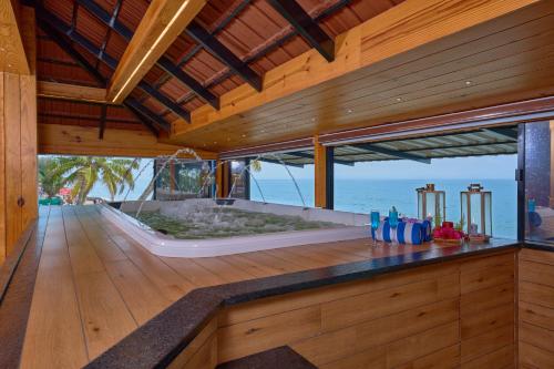 a large bath tub in a room with the ocean at Maliekal Heritance Cherai Beach Cochin in Cherai Beach