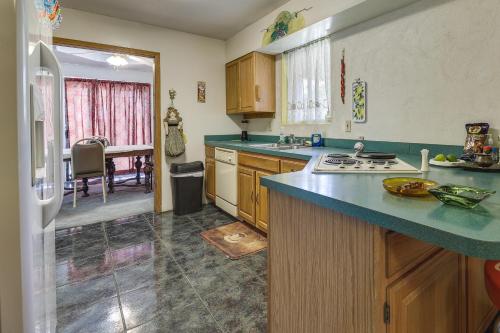 a kitchen with wooden cabinets and a blue counter top at Screened Porch Remote Harlingen House! in Harlingen