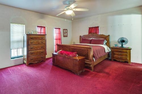 a bedroom with a large bed and a dresser at Remote Pet-Friendly Harlingen House! in Harlingen
