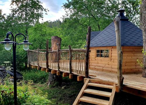 a log cabin with a bridge in the woods at hutzenAlm in Nassau