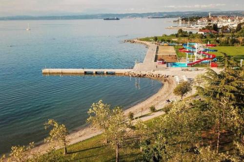 a beach with a pier in the water at Room 400 m from the beach in Izola