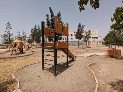 an empty park with a playground with a slide at appartement luxueux in Agadir