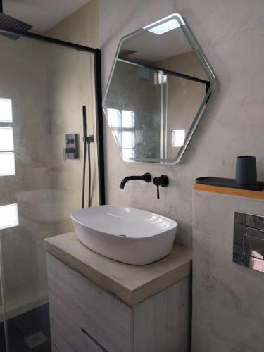 a bathroom with a white sink and a mirror at La Bellamar - Apartamento en primera línea mar- in Premiá de Mar