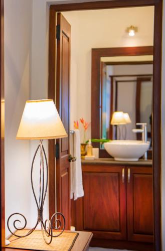 a lamp sitting on a table in a bathroom at 3 Sisters Beach House in Matara