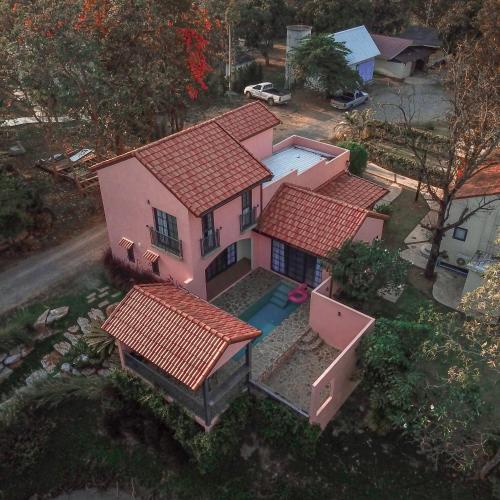 an overhead view of a pink house with red roofs at Pink Villa by Tubtao Sleepy Hill in Pong Talong