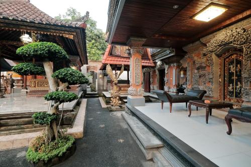 ウブドにあるSumantra Guest Houseの盆栽の木が目の前に立つ建物