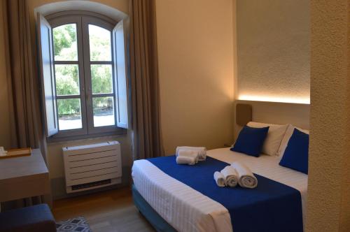 TANIT ROOMS & SPA في فيلاسيميوس: غرفة نوم بسريرين عليها مناشف