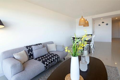 a living room with a couch and a table at Oceana Suites Lumiere in Punta del Este