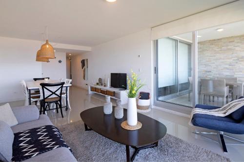 埃斯特角城的住宿－Oceana Suites en Lumiere, frente a playa Mansa，客厅配有沙发和桌子