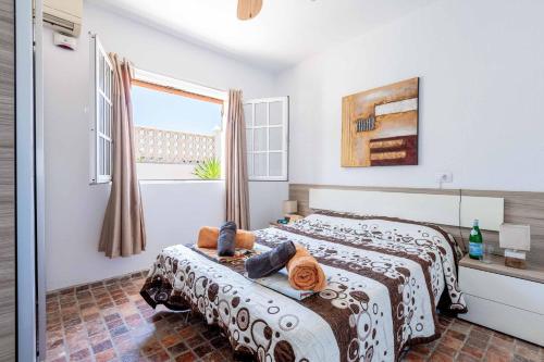 a bedroom with two beds and a window at Villa Lory in Callao Salvaje